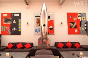 metal spaceship sculpture and red and black wall art in paris loft Interior Design Blogs