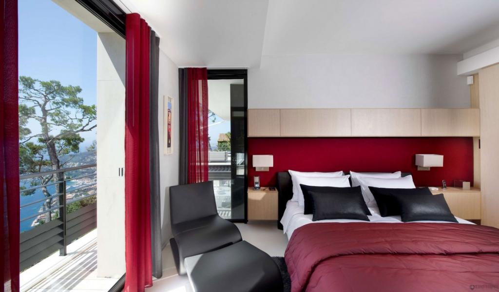 luxury-bed-room-with-comfort-bed-translucent-window-glass-with-red-curtains-also-the-prety-view-outside