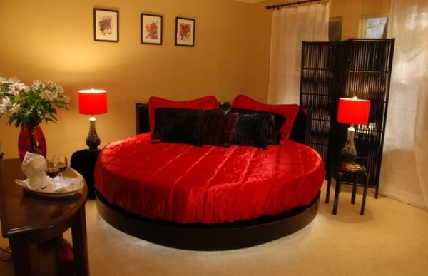 Satin-covered-round-bed-in-scarlet-and-black-hues-for-a-perfect-romantic-bedroom-theme