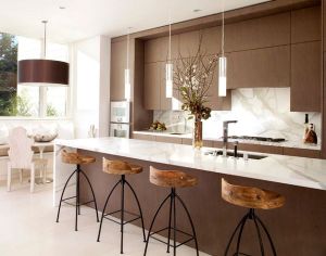 Exquisite modern kitchen in white and brown with sleek pendant lights above the kitchen island Interior Design Blogs